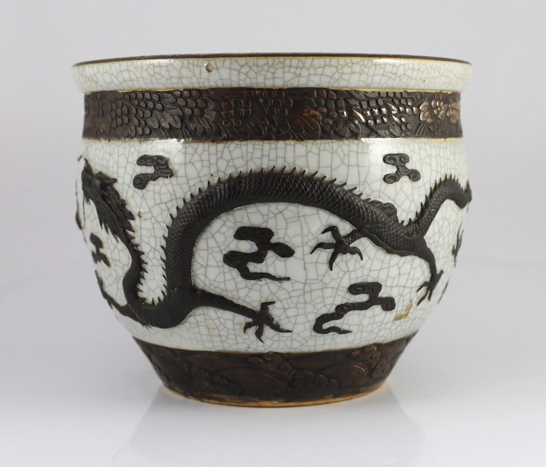 A Chinese crackle glaze 'dragon' jardiniere, late 19th century, 31.6cm diameter, 25.5cm high, star crack to base